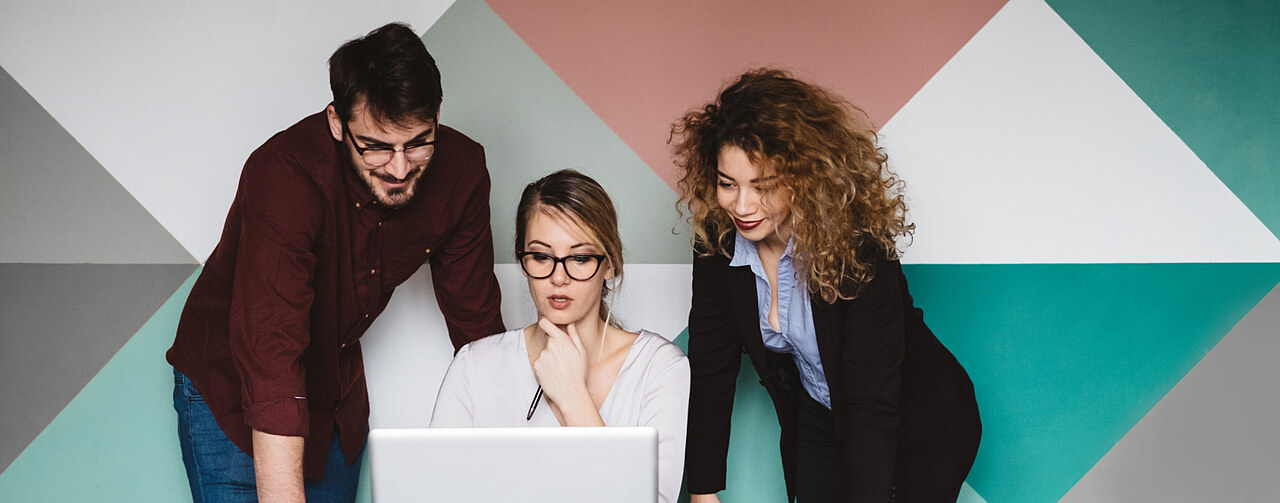 People gathered over a laptop