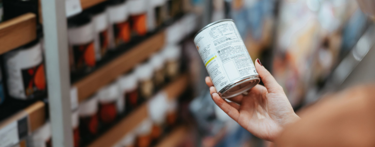 Hand holding a can of food