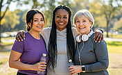 Three women standing next to each other outside
