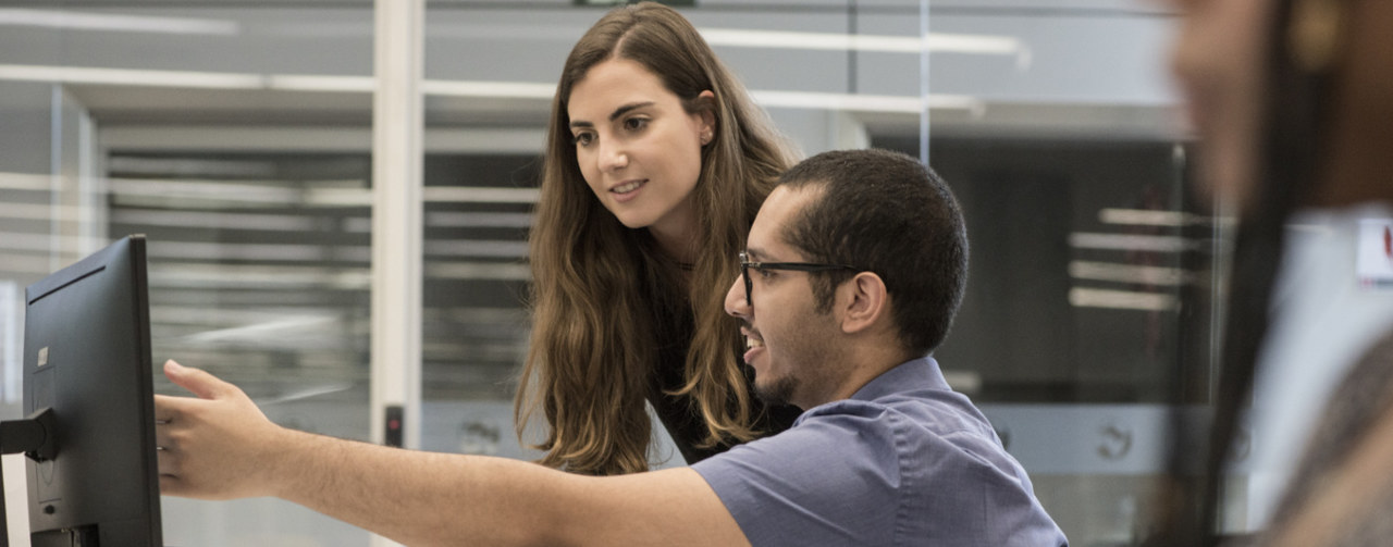 Man and woman looking at a computer