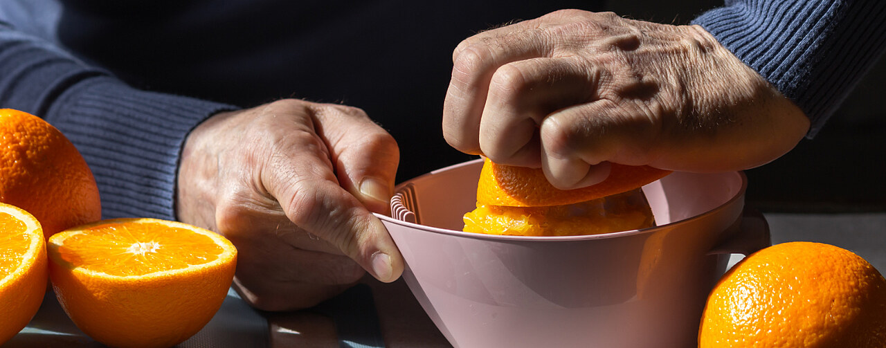 Hand squeezing an orange