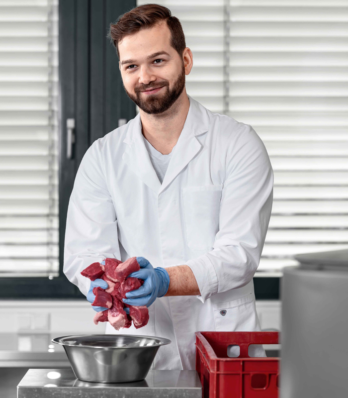 man with meat pieces in his hands