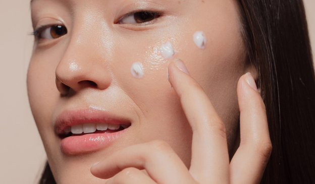 Woman applying face cream