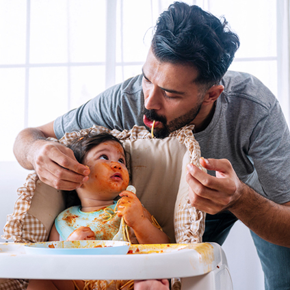 man feeding a liitle girl 