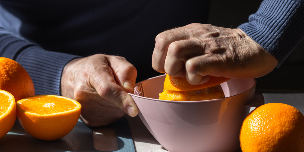 Hand squeezing an orange