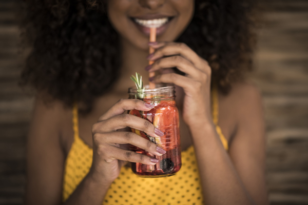 Symlife™ sweet Woman with a beverage and straw