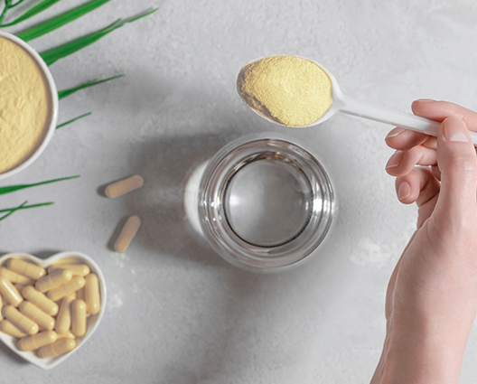 Spoon of powder and a glass of water