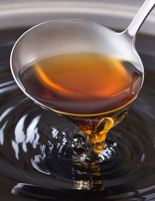 Chicken broth in a laddle