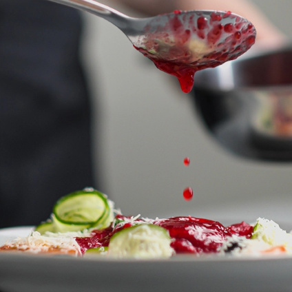 Sauce being drizzled over food