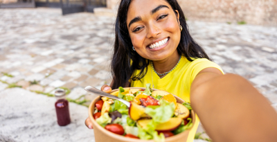 Weight management white paper Woman eating a salad outdoors