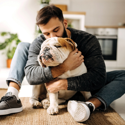 Man cuddling with dog