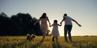 Family with dog on meadow